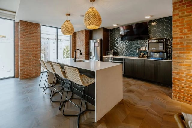 Island bar with stools stainless steel appliances kitchen at Industry Cincinnati in Cincinnati Student Accommodation