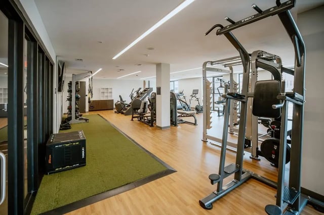 Gym equipment and green turf area Gym at Industry Cincinnati in Cincinnati Student Accommodation