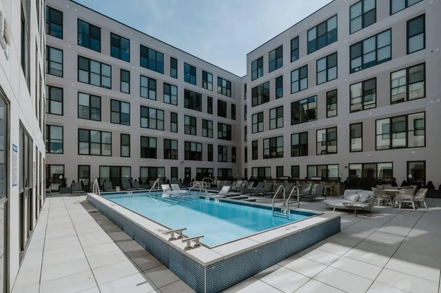 Courtyard apartment building with pool and lounge chairs exterior at Industry Cincinnati in Cincinnati Student Accommodation