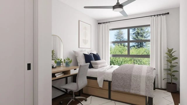 Bed desk chair plants and window Bedroom at Rambler Columbus in Columbus Student Accommodation