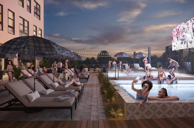 People relaxing by pool with outdoor TV playing exterior at Rambler Columbus in Columbus Student Accommodation