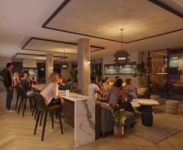 People gather around counter and sofas living room at Rambler Columbus in Columbus Student Accommodation