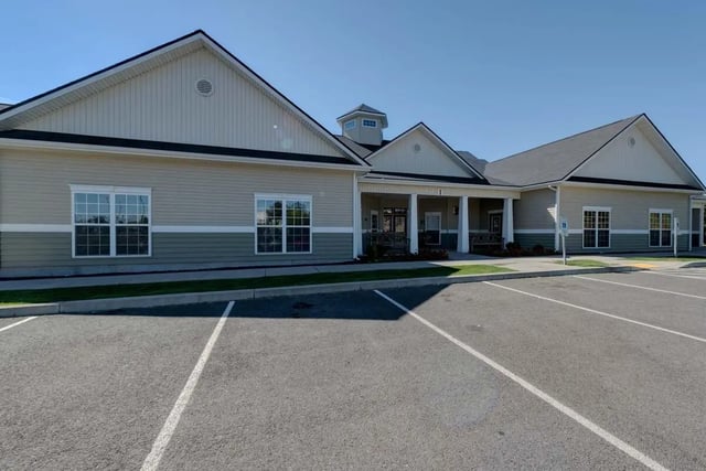 Low rise building with parking lot Exterior at The Grove at Cheney in Cheney Student Accommodation