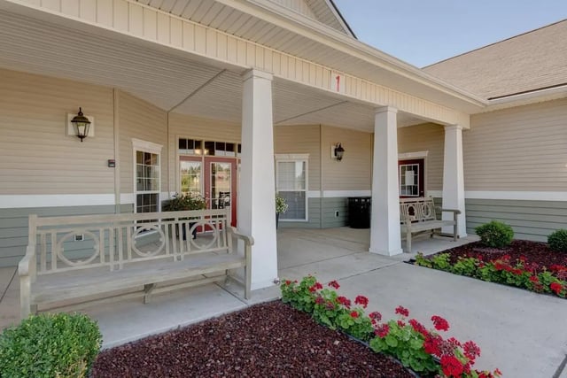Benches by entrance with planters and building exterior exterior at The Grove at Cheney in Cheney Student Accommodation