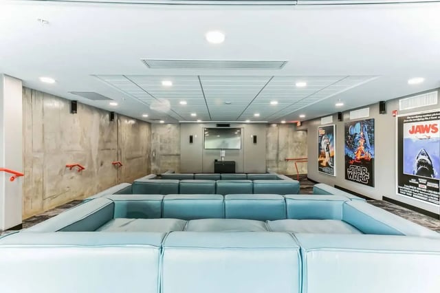 Theater seating with movie posters lounge area at Current Midtown in Williamsburg Student Accommodation