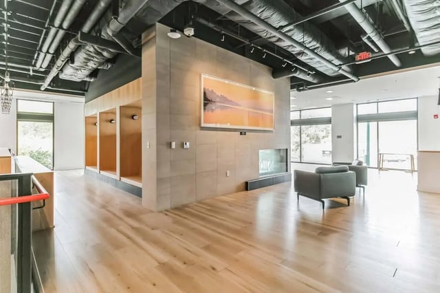Open lounge area with recessed seating and chairs at Current Midtown in Williamsburg Student Accommodation