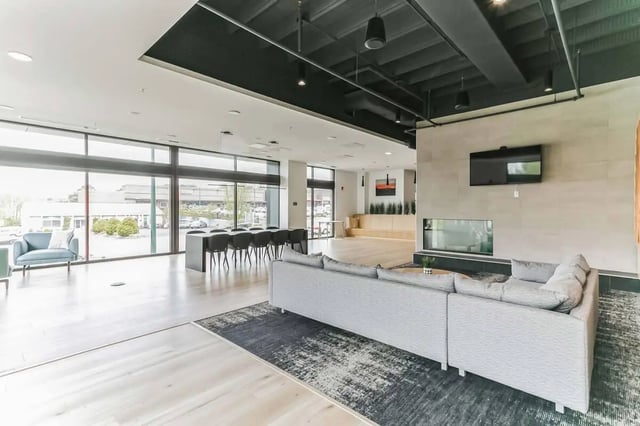 Modern lounge area with sofa and fireplace living room at Current Midtown in Williamsburg Student Accommodation