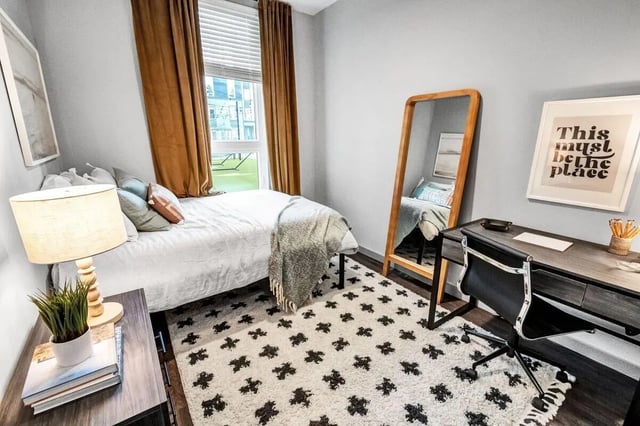 Bed desk rug mirror framed art bedroom at Junction 49 in Charlotte Student Accommodation