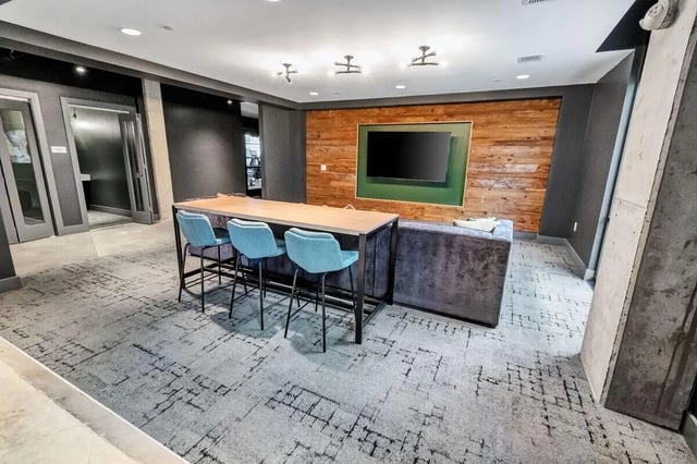 Bar seating and couch in common area living room at Junction 49 in Charlotte Student Accommodation