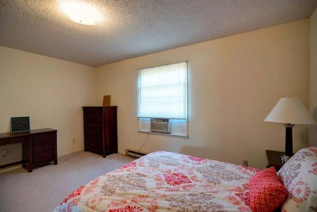 Bed dresser window air conditioner lamp bedroom at Grand Duke in Harrisonburg Student Accommodation