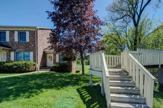 Brick townhouses with white decks and stairs exterior at Grand Duke in Harrisonburg Student Accommodation