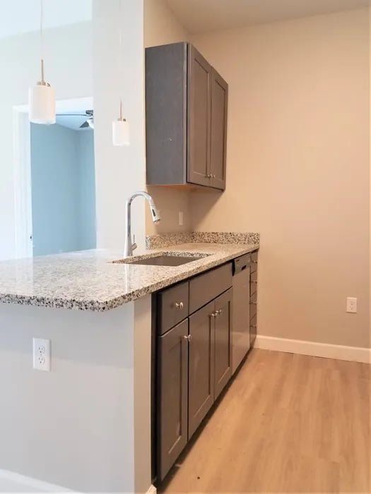 Kitchen island with sink and cabinets kitchen at Peak of Boone in Boone Student Accommodation