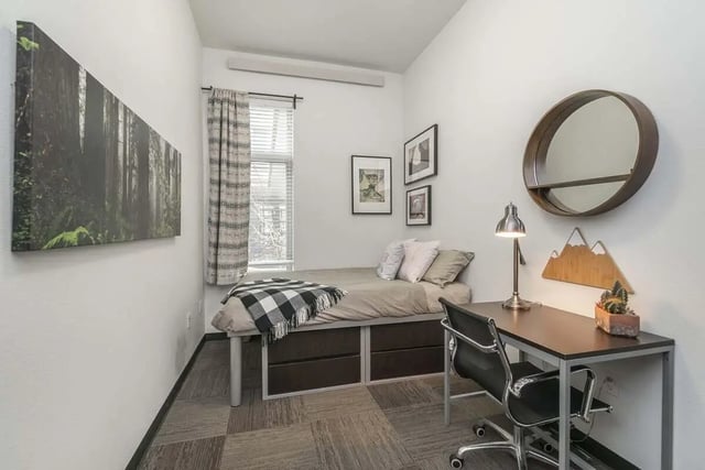 Bed desk chair artwork and mirror bedroom at Arena District in Eugene Student Accommodation