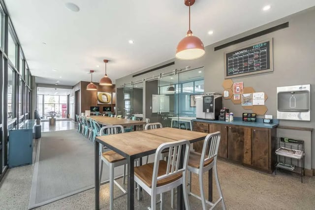 Dining tables coffee station calendar community space at Arena District in Eugene Student Accommodation
