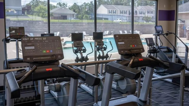 Treadmills ellipticals and stair climber gym fitness area at Copper Beech Townhomes - Harrisonburg in Harrisonburg Student Accommodation