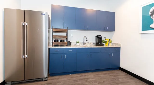 Stainless steel refrigerator blue cabinets coffee maker kitchen at Rivers Walk in Boone Student Accommodation