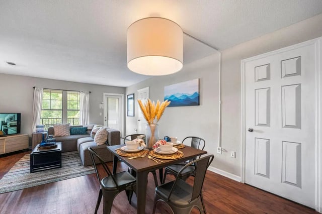 Dining table with chairs and living room living room at The Wilde Raleigh in Raleigh Student Accommodation