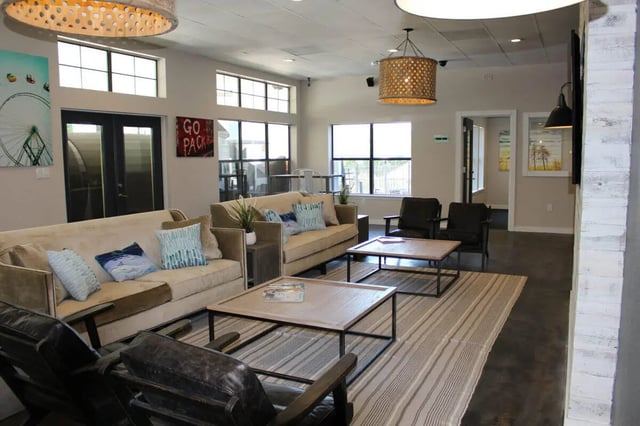 Sofa tables chairs and rug living room at The Wilde Raleigh in Raleigh Student Accommodation