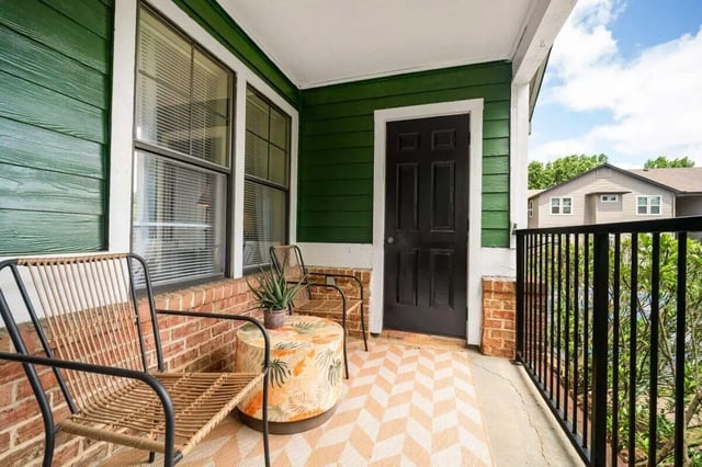 Chairs plant table and door exterior at The Wilde Raleigh in Raleigh Student Accommodation