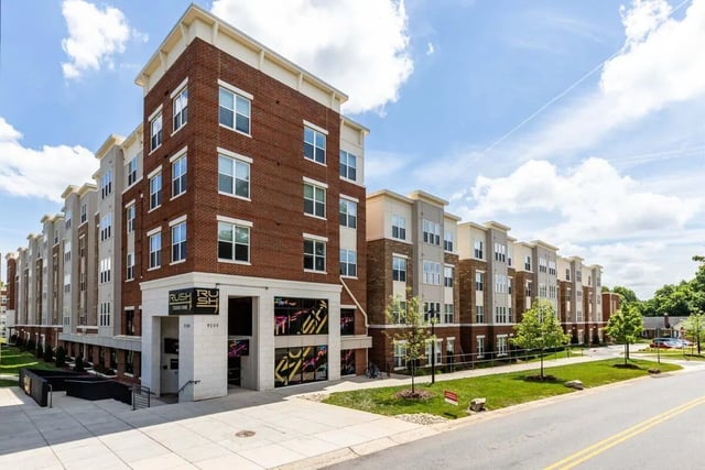 Modern apartment building with brick and gray siding exterior at Rush Charlotte in Charlotte Student Accommodation