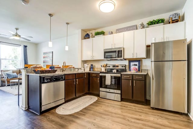 Stainless steel appliances granite countertops and cabinetry kitchen at Rush Charlotte in Charlotte Student Accommodation