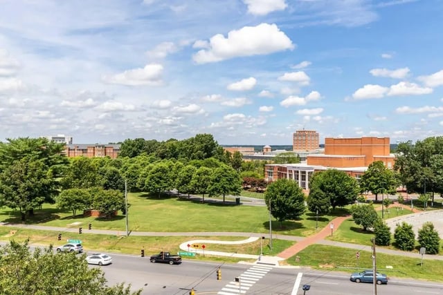 Campus buildings green lawns and distant cityscape exterior at Rush Charlotte in Charlotte Student Accommodation