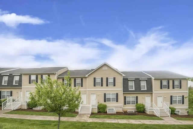 Townhouses with stairs windows and green trees exterior at Copper Beech Townhomes - Radford in Radford Student Accommodation