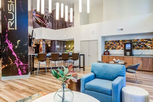 Blue armchairs high table with stools living area at Rush Charlotte in Charlotte Student Accommodation