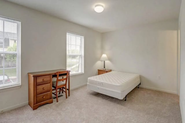 Desk chair mattress lamp and windows bedroom at Copper Beech Townhomes - Radford in Radford Student Accommodation