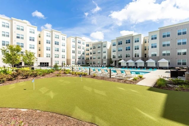 Mini golf course near pool and apartment buildings exterior at Rush Charlotte in Charlotte Student Accommodation