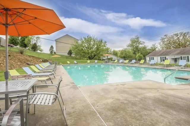 Poolside lounge chairs and tables outdoor area at Copper Beech Townhomes - Radford in Radford Student Accommodation