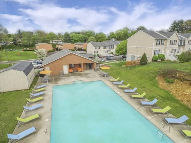 Pool lounge chairs pool building exterior at Copper Beech Townhomes - Radford in Radford Student Accommodation