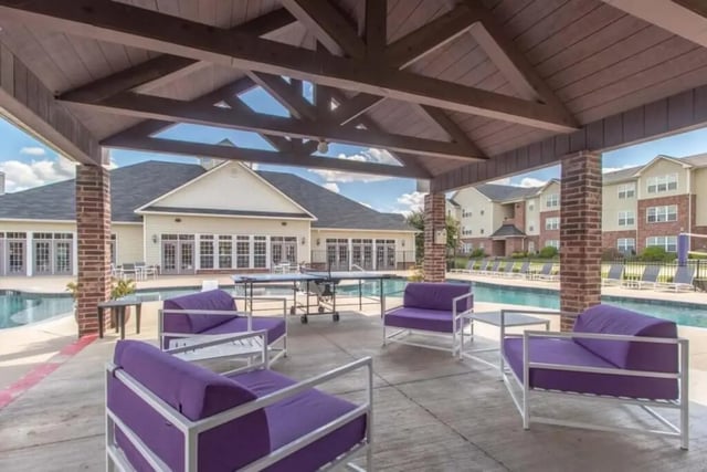 Purple seating and ping pong table by pool exterior at Grove at Stephenville in Stephenville Student Accommodation