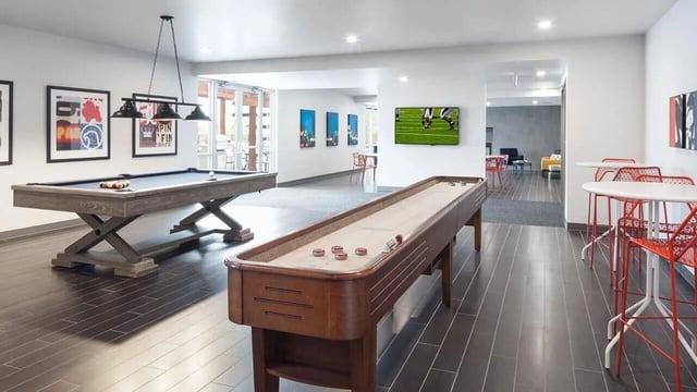 Pool table shuffleboard and seating area recreation room at Latitude Lincoln in Lincoln Student Accommodation