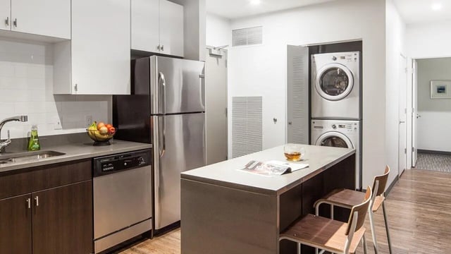 Stainless steel appliances island with chairs kitchen at Latitude Lincoln in Lincoln Student Accommodation