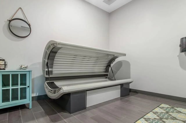 Tanning bed next to cabinet and mirror tanning bed at Latitude Lincoln in Lincoln Student Accommodation