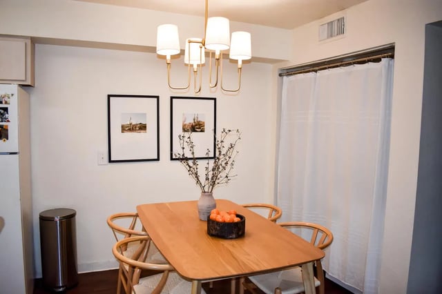 Wooden table with chairs modern chandelier artwork Dining area at Table Rock in Flagstaff Student Accommodation