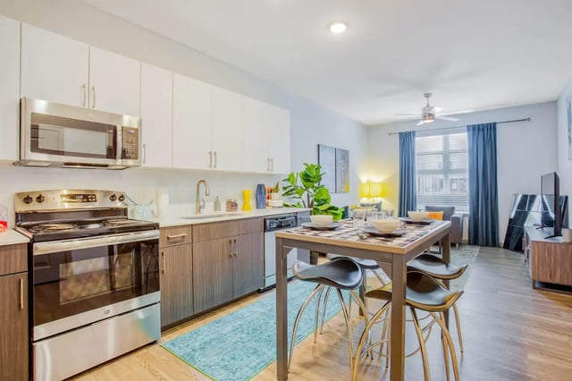 Kitchen with dining table and bar stools living area kitchen at Liv+ Arlington in Arlington Student Accommodation
