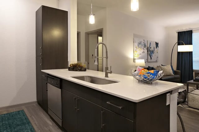 Kitchen island with sink dishwasher and snacks kitchen at Liv+ Arlington in Arlington Student Accommodation