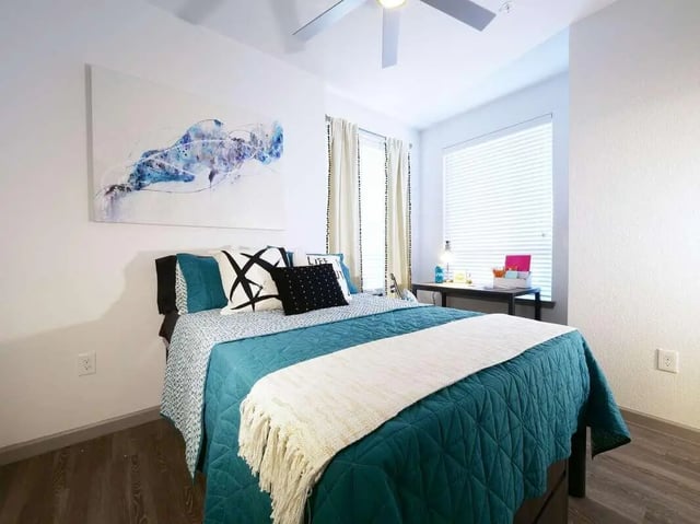Bed pillows desk and artwork bedroom at Liv+ Arlington in Arlington Student Accommodation