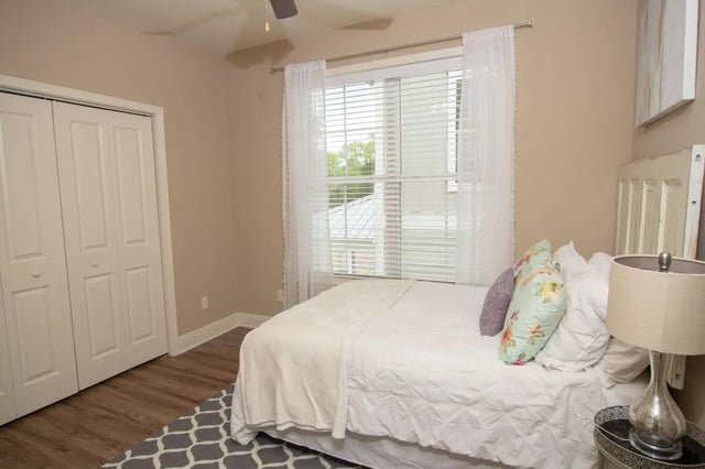 Bed with pillows closet and window bedroom at Village Walk Oxford Apartments in Oxford Student Accommodation