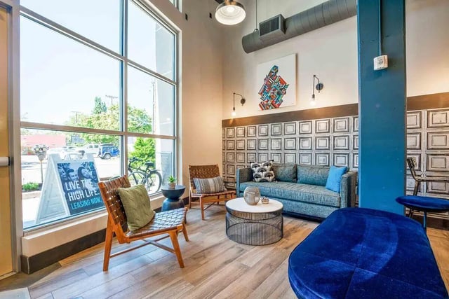 Sofa chairs coffee table artwork patterned wall living room at Patterson Social in Eugene Student Accommodation
