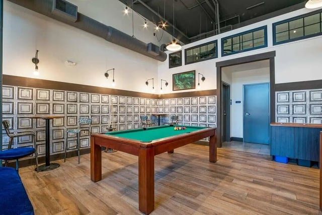 Pool table with billiards balls and cues playing area at Patterson Social in Eugene Student Accommodation