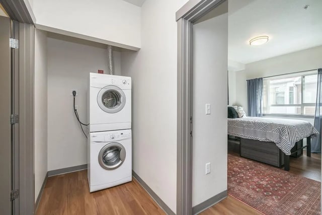Stacked white washer dryer laundry area bedroom at Patterson Social in Eugene Student Accommodation