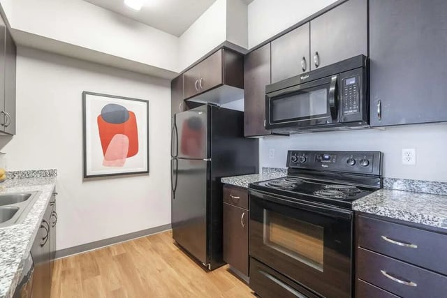 Black refrigerator microwave oven and stove kitchen at Patterson Social in Eugene Student Accommodation