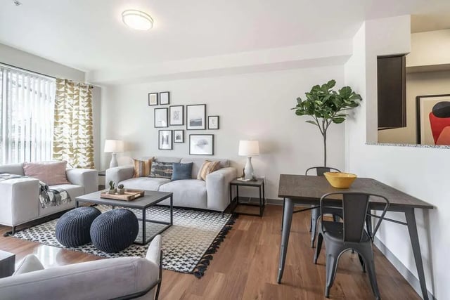 Gray sofas with pillows dining table chairs living area at Patterson Social in Eugene Student Accommodation