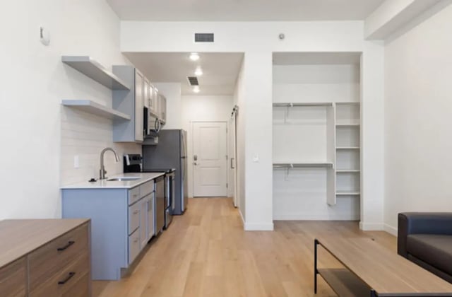 Kitchen living area with open closet living room at Ivory University House in Salt Lake City Student Accommodation