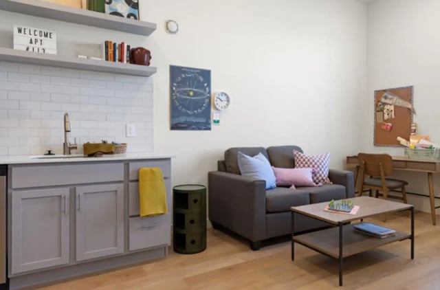 Sofa desk and kitchenette living area at Ivory University House in Salt Lake City Student Accommodation