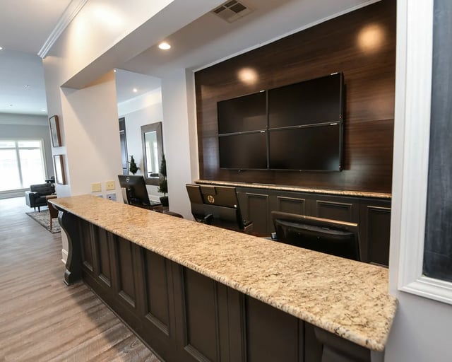 Reception desk with monitors and large screens lobby at The Verge at Grand Forks in Grand Forks Student Accommodation