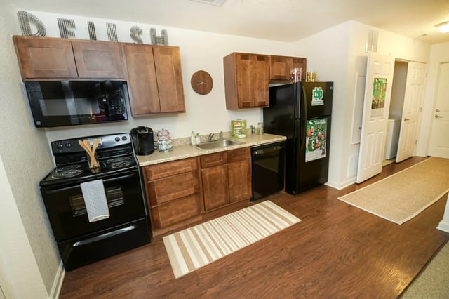 Kitchen with microwave stove sink and refrigerator kitchen at The Verge at Grand Forks in Grand Forks Student Accommodation